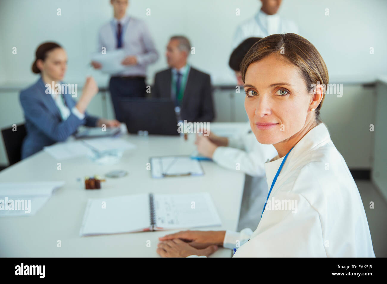 Scientist sitting in meeting Stock Photo