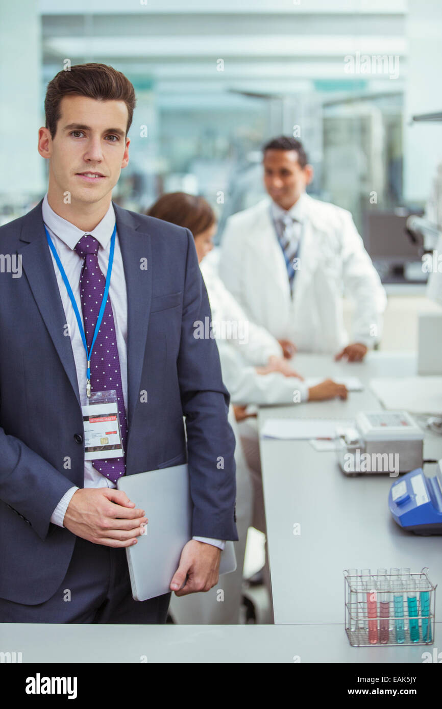 Businessman holding laptop in laboratory Stock Photo