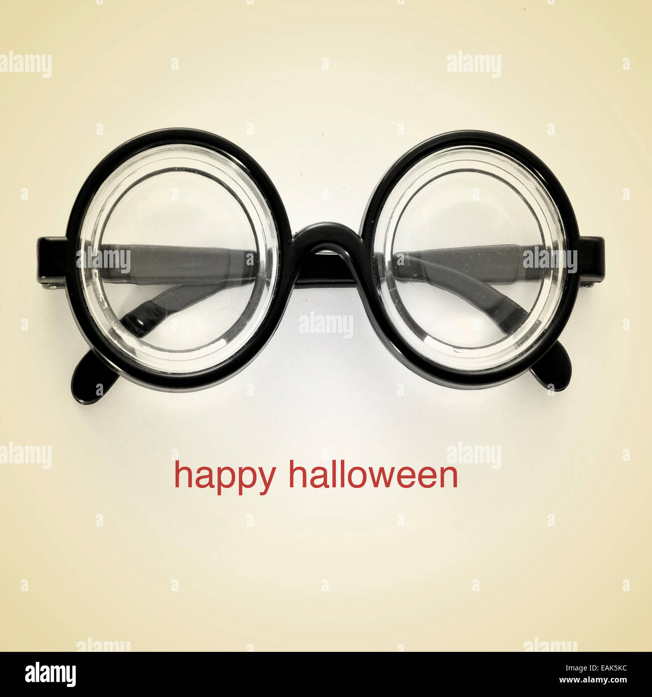 picture of short-sighted glasses and the sentence happy halloween on a beige background, with a retro effect Stock Photo