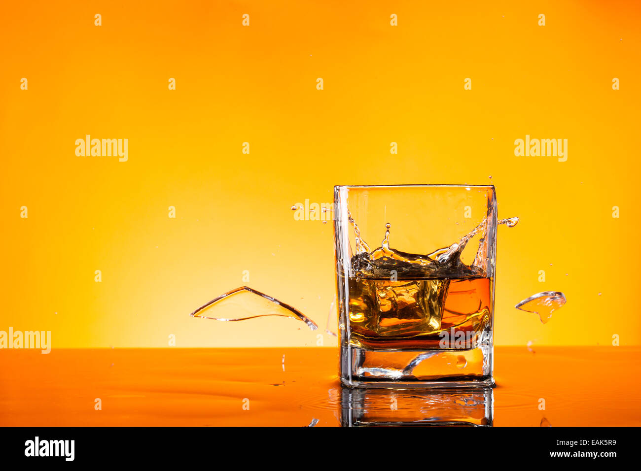 Freeze motion of whiskey drink with boken piece of glass Stock Photo