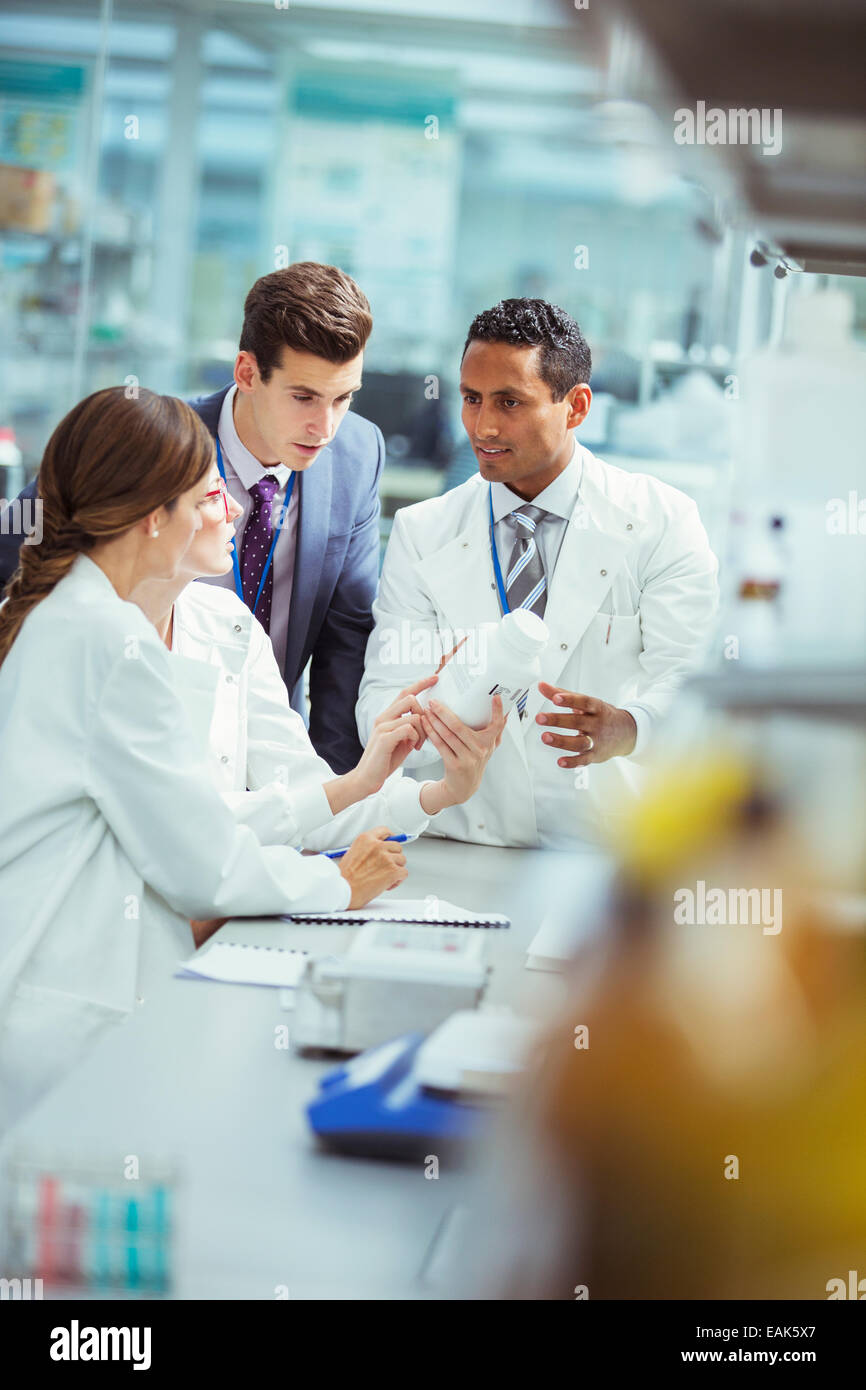 Scientists and businessman talking in laboratory Stock Photo