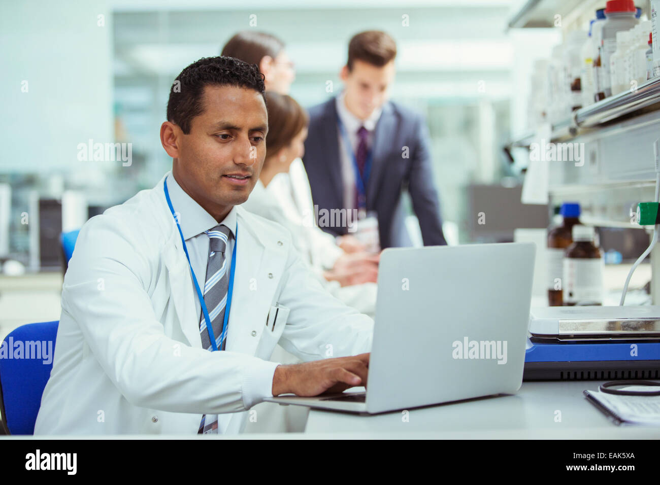 Scientist using laptop in laboratory Stock Photo