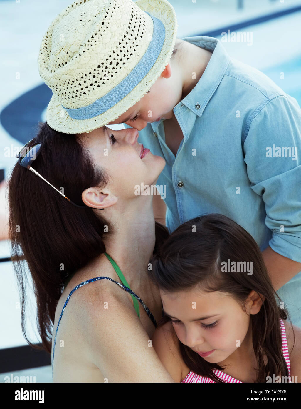 Mother hugging son and daughter Stock Photo