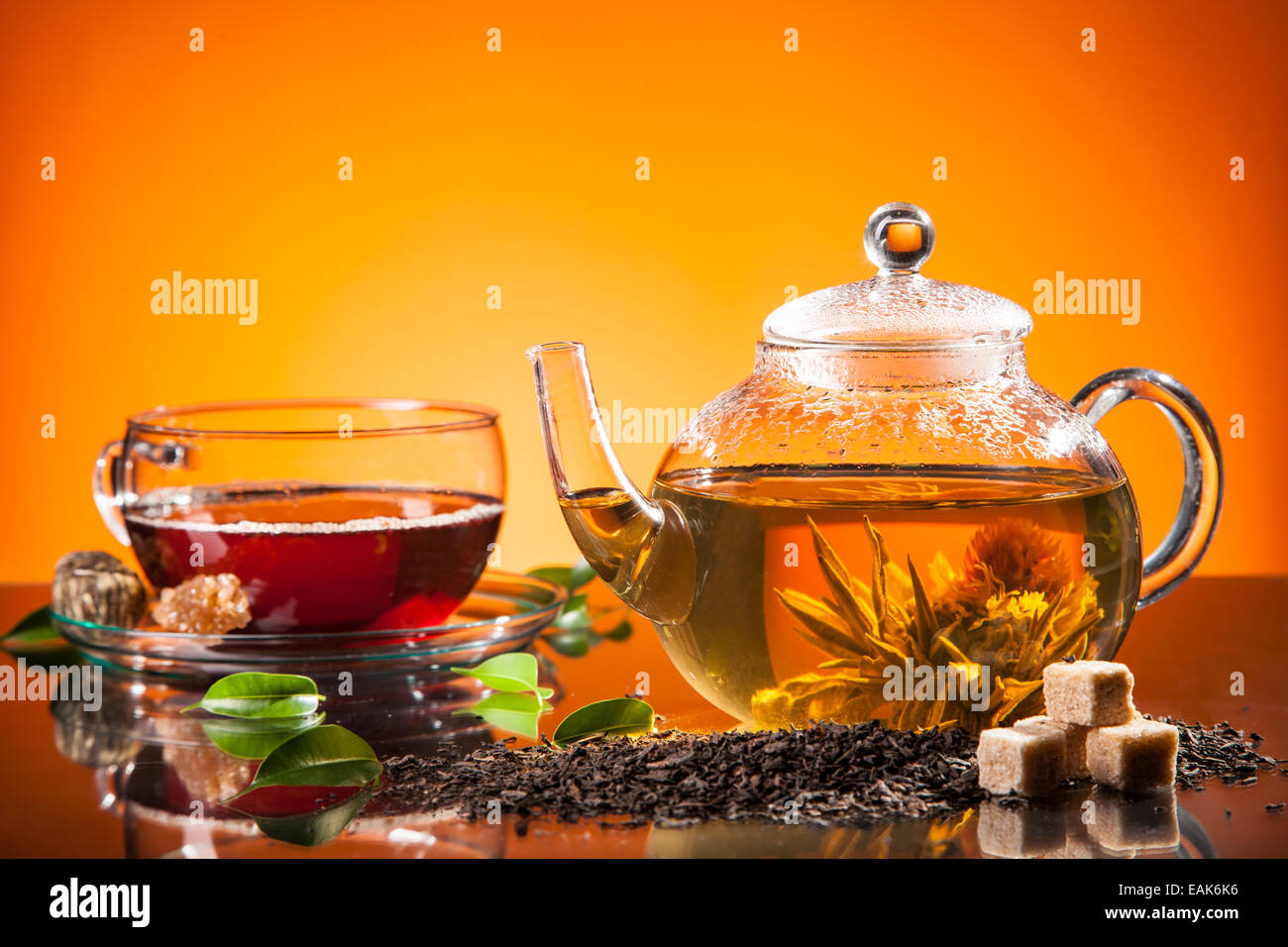 Teapot and cup with blooming tea on glass Stock Photo Alamy