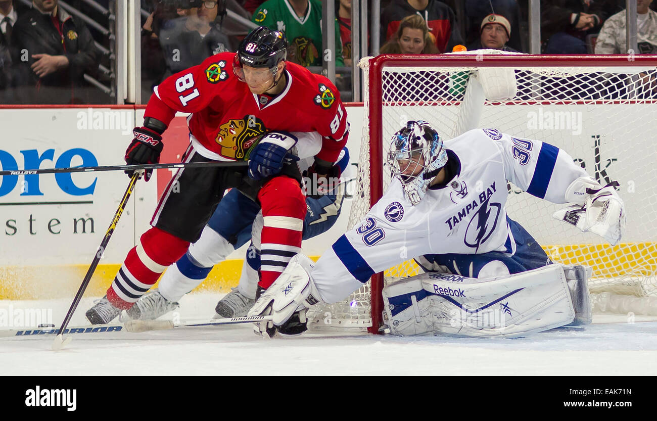 November 11, 2014: Chicago, Illinois, U.S. - Blackhawk #81 Marian Hossa is poke checked by Lightning Goaltender #30 Ben Bishop during the National Hockey League game between the Chicago Blackhawks and the Tampa Bay Lightning at the United Center in Chicago, IL. Stock Photo