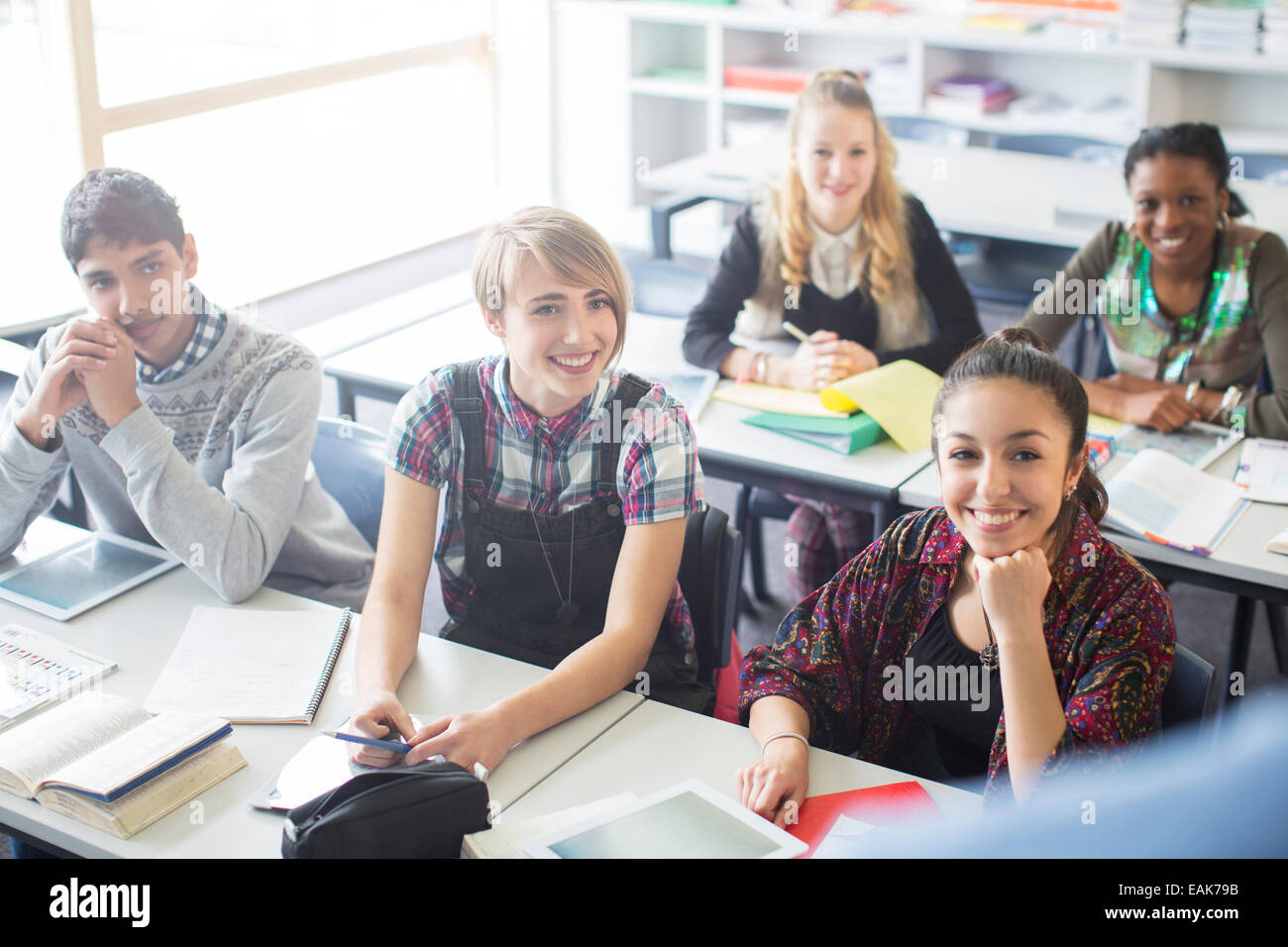 Teenage students learning in classroom Stock Photo