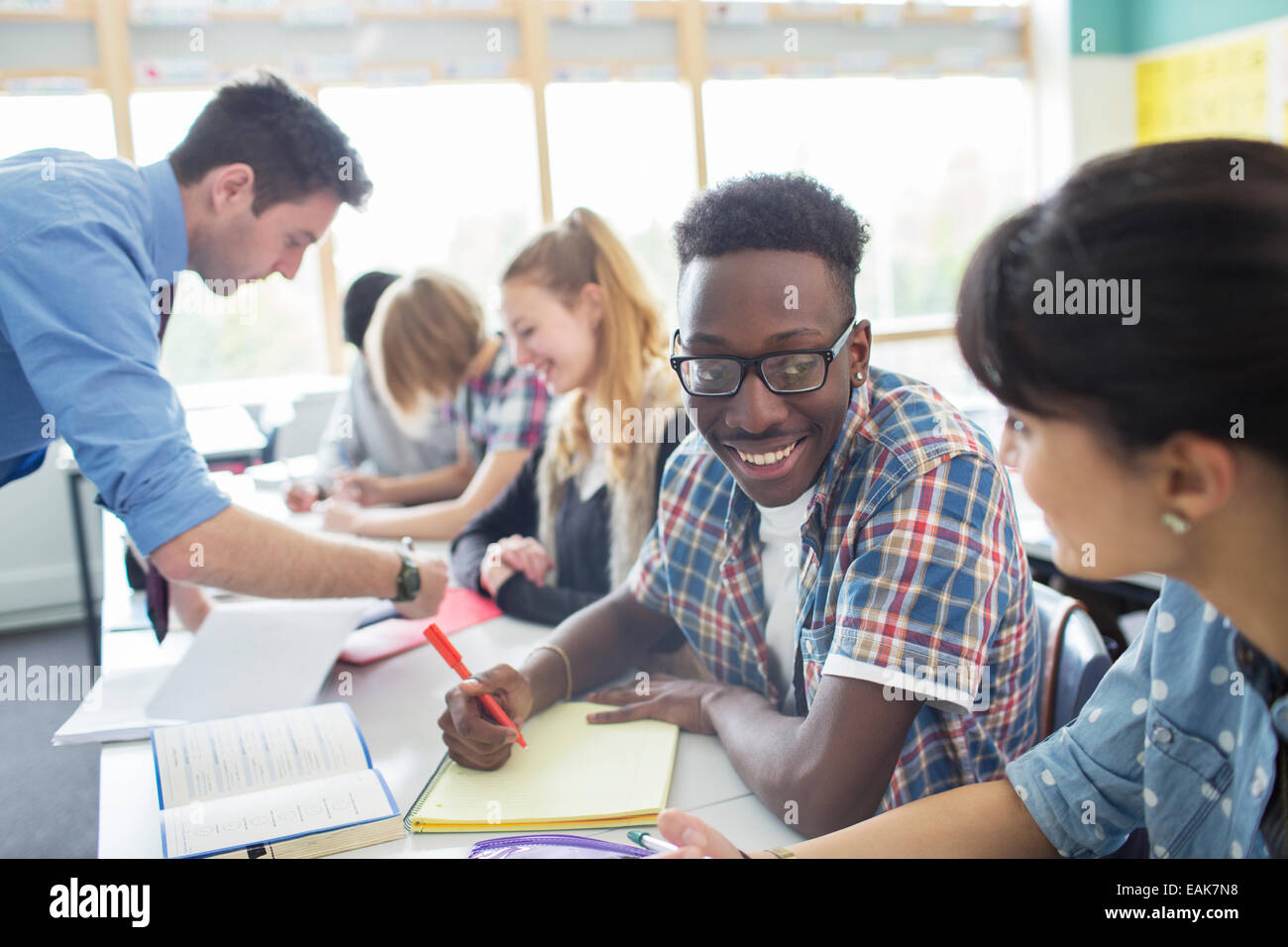 Teacher with his students in classroom Stock Photo