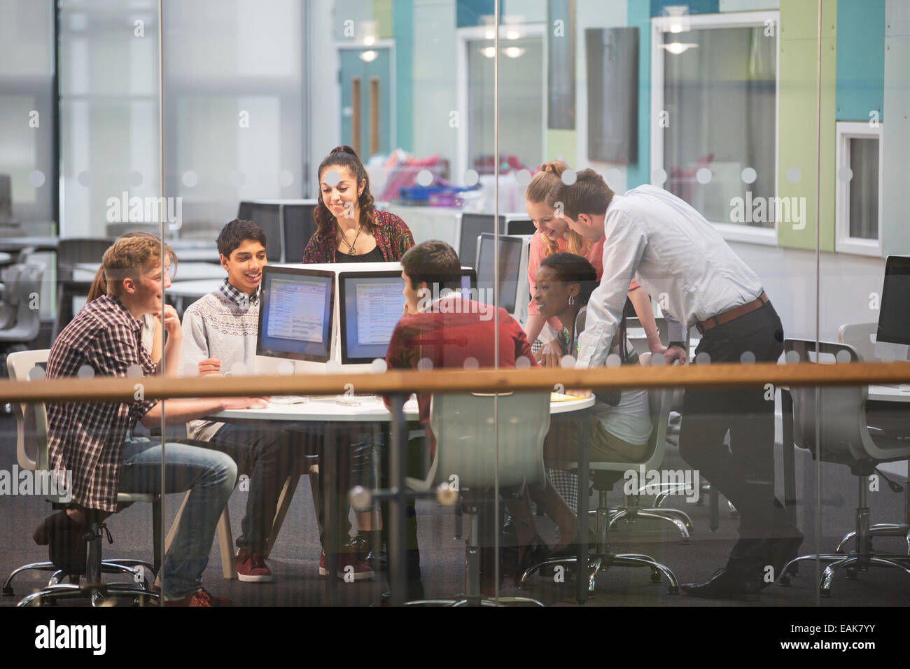 Students during IT lesson in modern classroom with glass walls Stock Photo