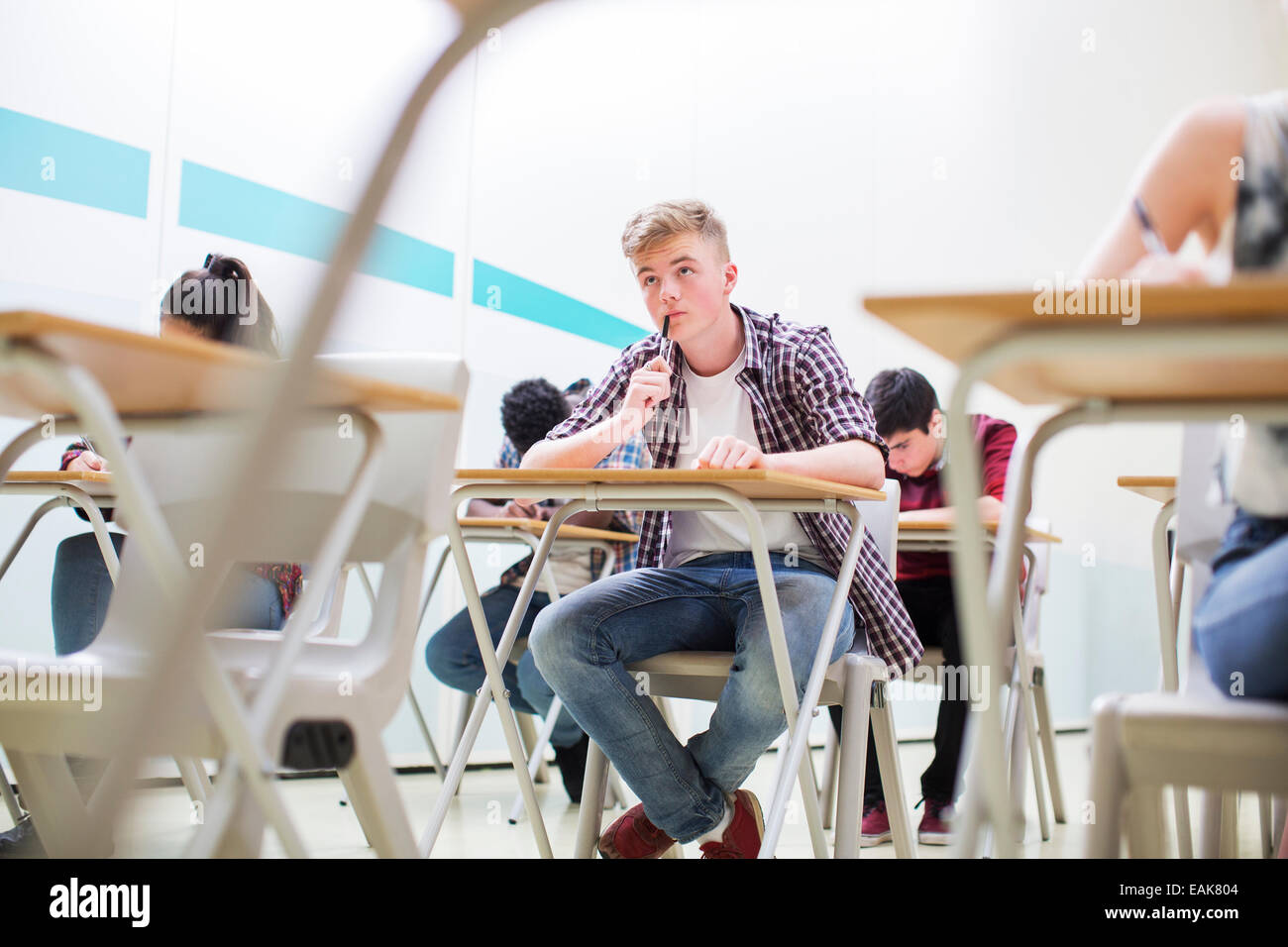 Students writing their GCSE exam in classroom Stock Photo