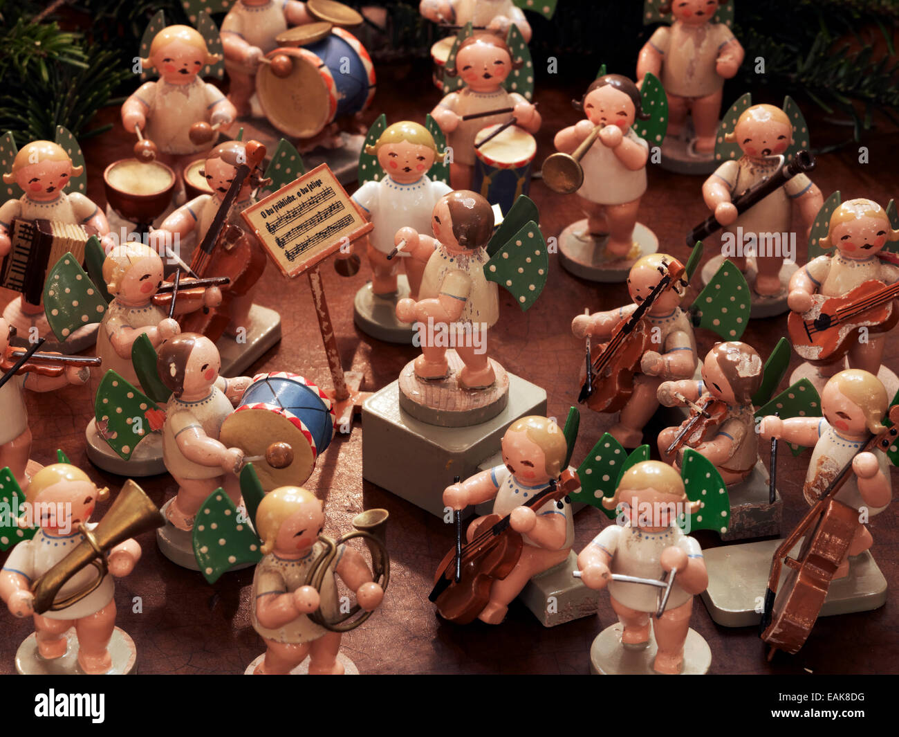 Handmade wooden angels playing musical instruments as a table