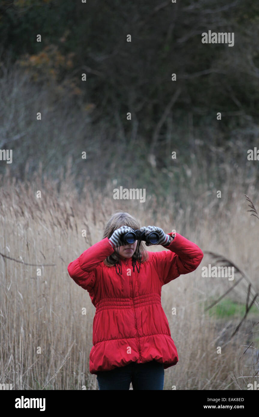 A 12 year old girl looking for birds through a pair of Binoculars Stock