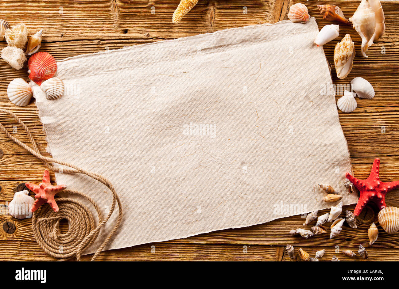 Concept of summer beach with starfish, shells and empty paper on wood Stock Photo