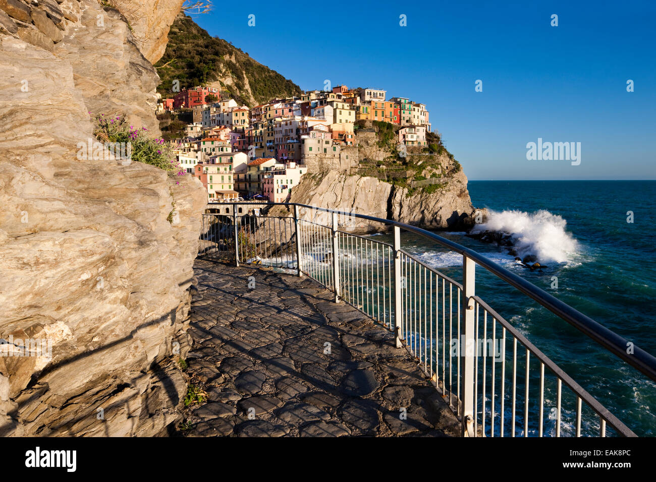 Hiking trail of Via dell' Amore in front of the houses of Manarola, UNESCO World Cultural Heritage Site, Manarola, Cinque Terre Stock Photo