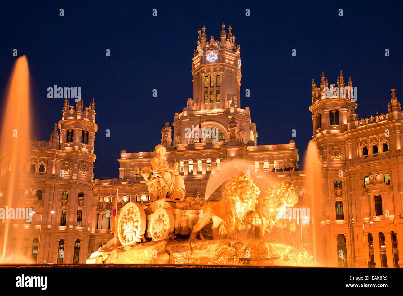 Illuminated Fuente de Cibeles fountain in front of the Palacio de Comunicaciones, the former Post Office, Madrid, Spain Stock Photo