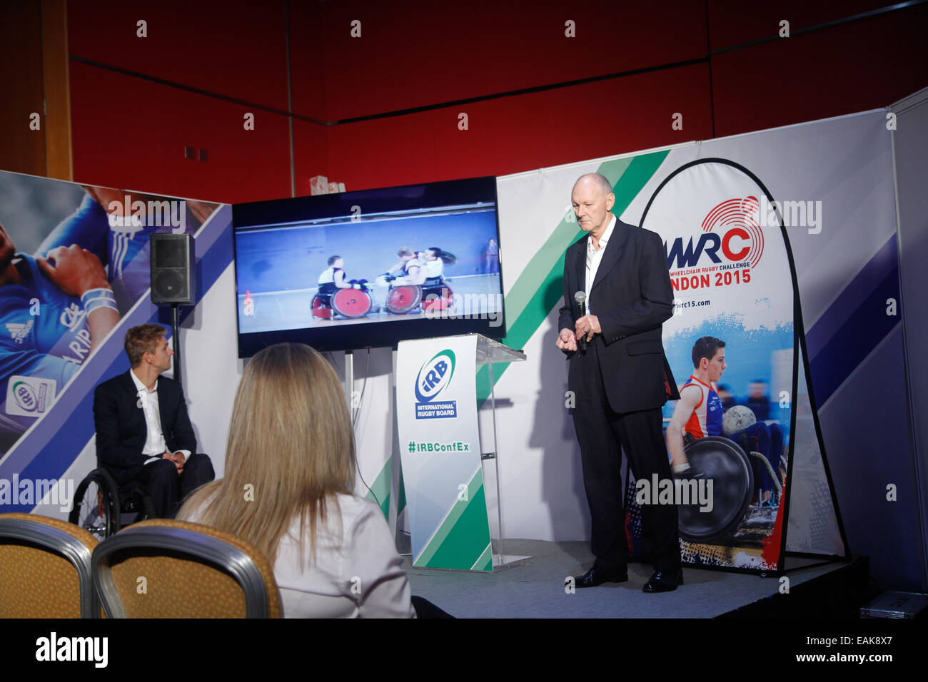 London, UK. 17th November 2014. David Pond, CEO Great Britain Wheelchair Rugby presents a video on the sport as Steve Brown, Team GB Captain watches on during the IRB World Rugby Conference and Exhibition in London. Credit:  Elsie Kibue/Alamy Live News Stock Photo