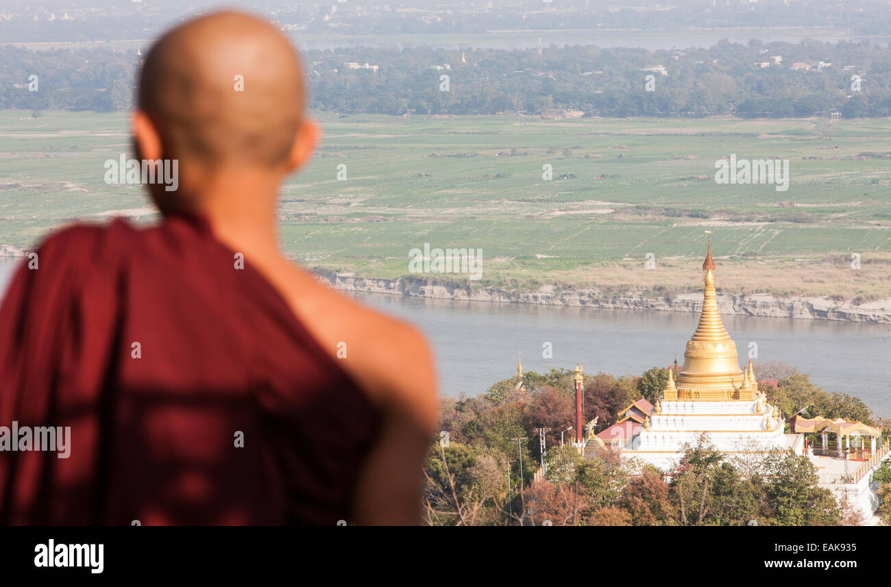 Buddhist monk observing the view from on top of Sagaing Hill,pagodas stupas and temples,near Mandalay,Burma,Myanmar,Asia. Stock Photo