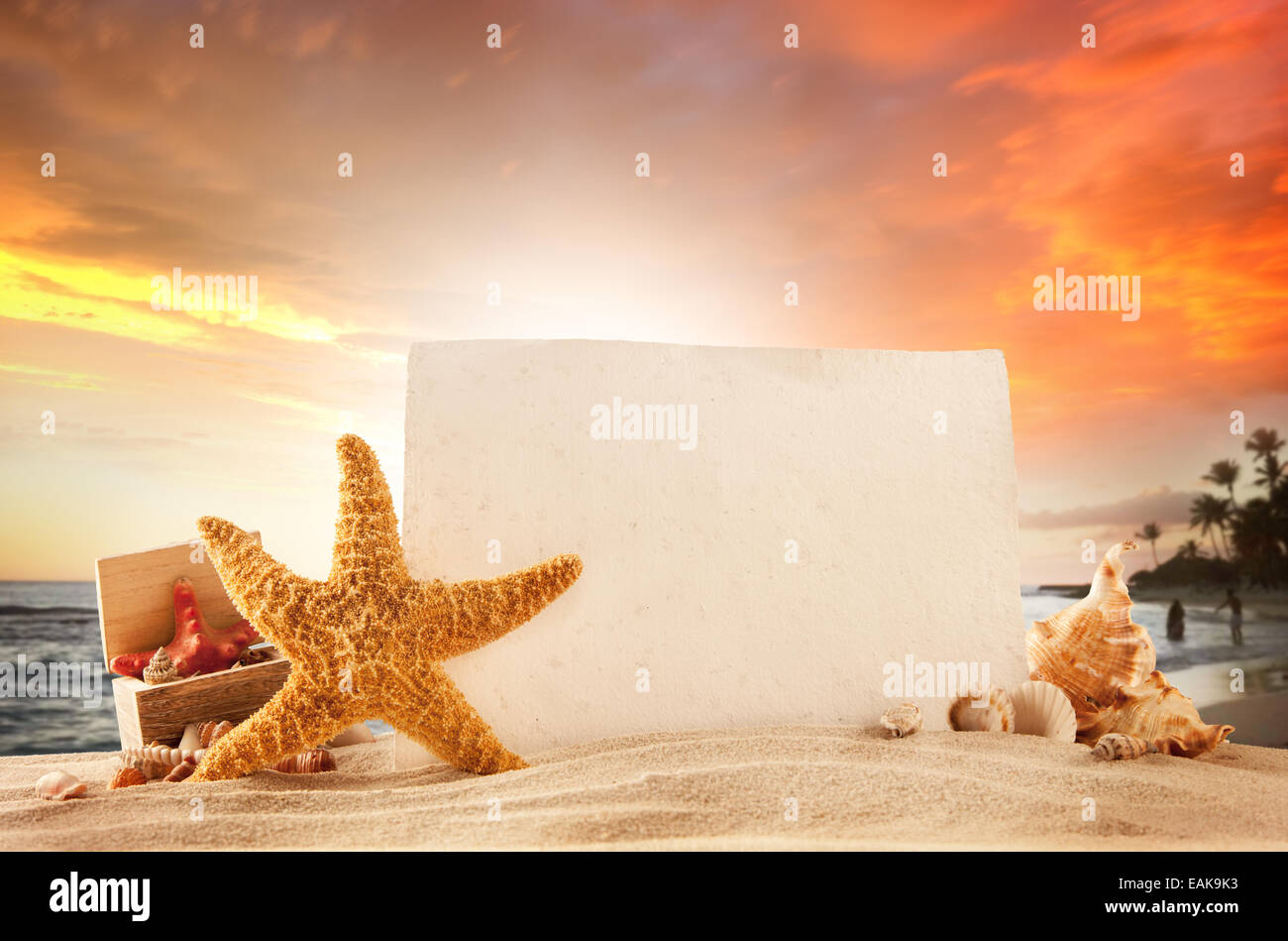 Concept of summer beach with starfish, shells and empty paper for message. Stock Photo