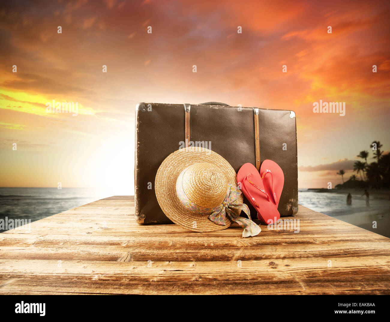 Concept of summer traveling with old suitcase and accessories. Blur beach on background Stock Photo