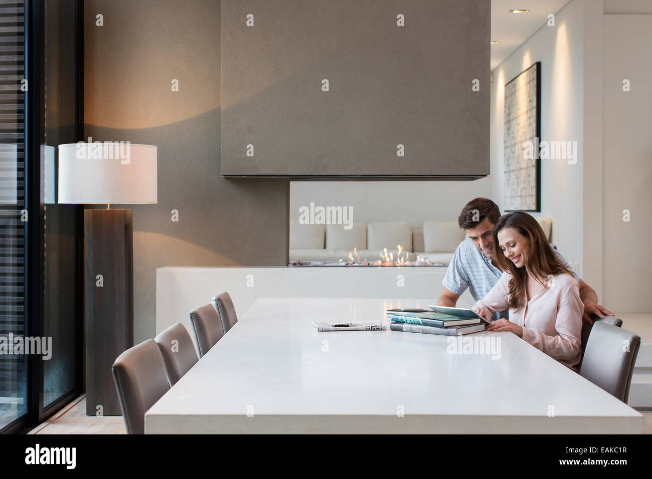 Couple using tablet pc in dining room Stock Photo