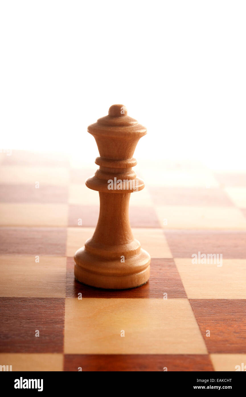 chess queen piece on chessboard Stock Photo
