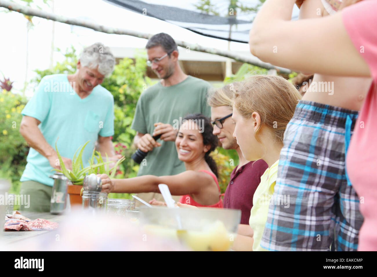 Men and women at table in garden Stock Photo