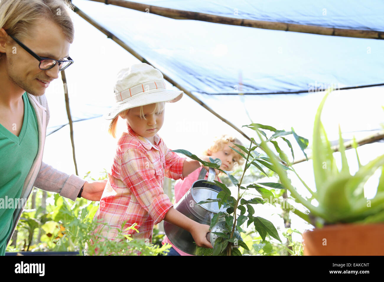 Girl and boy watering plants hi-res stock photography and images - Alamy