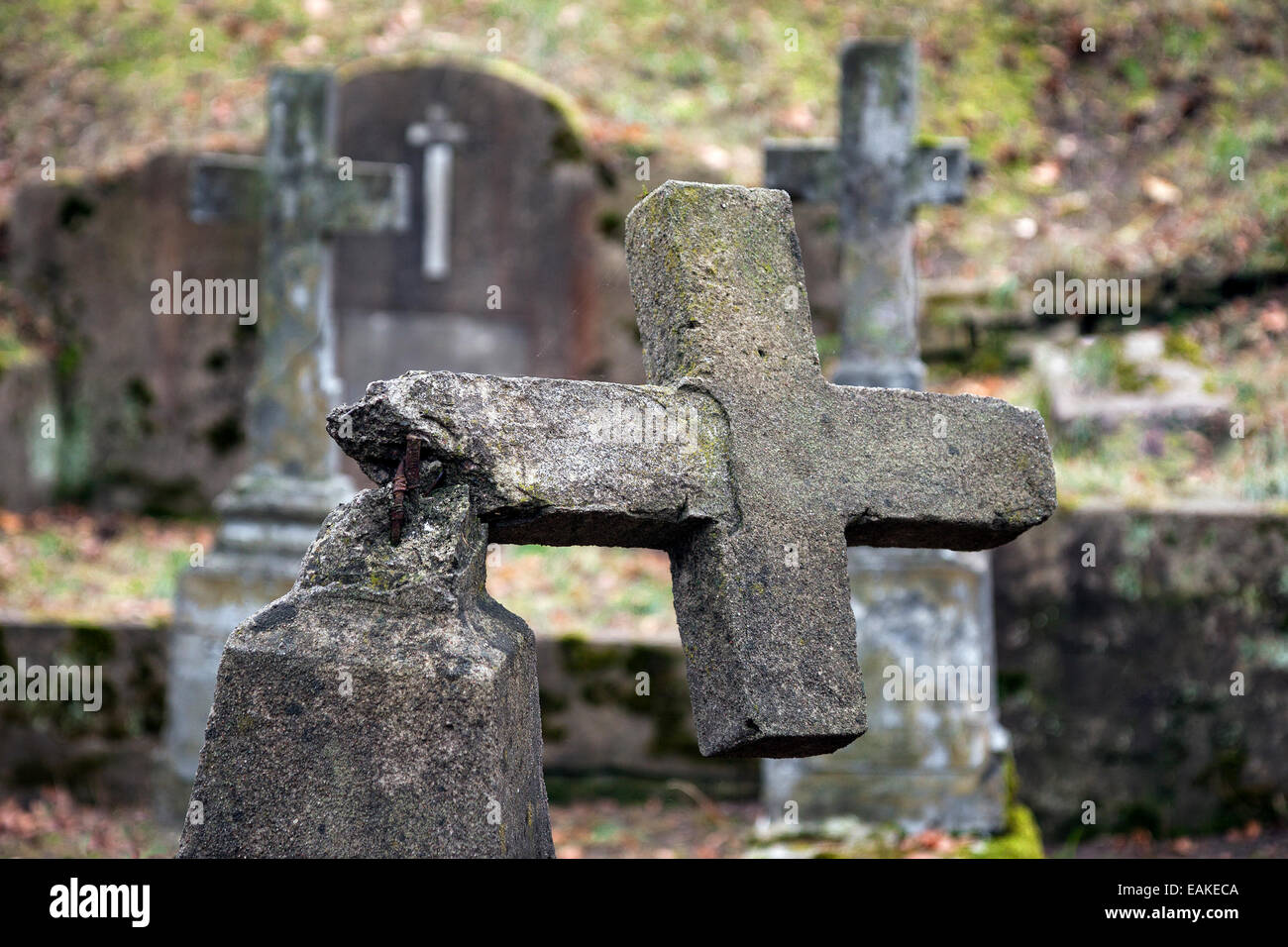 Ruined tombstone in old weathered cemetery Stock Photo