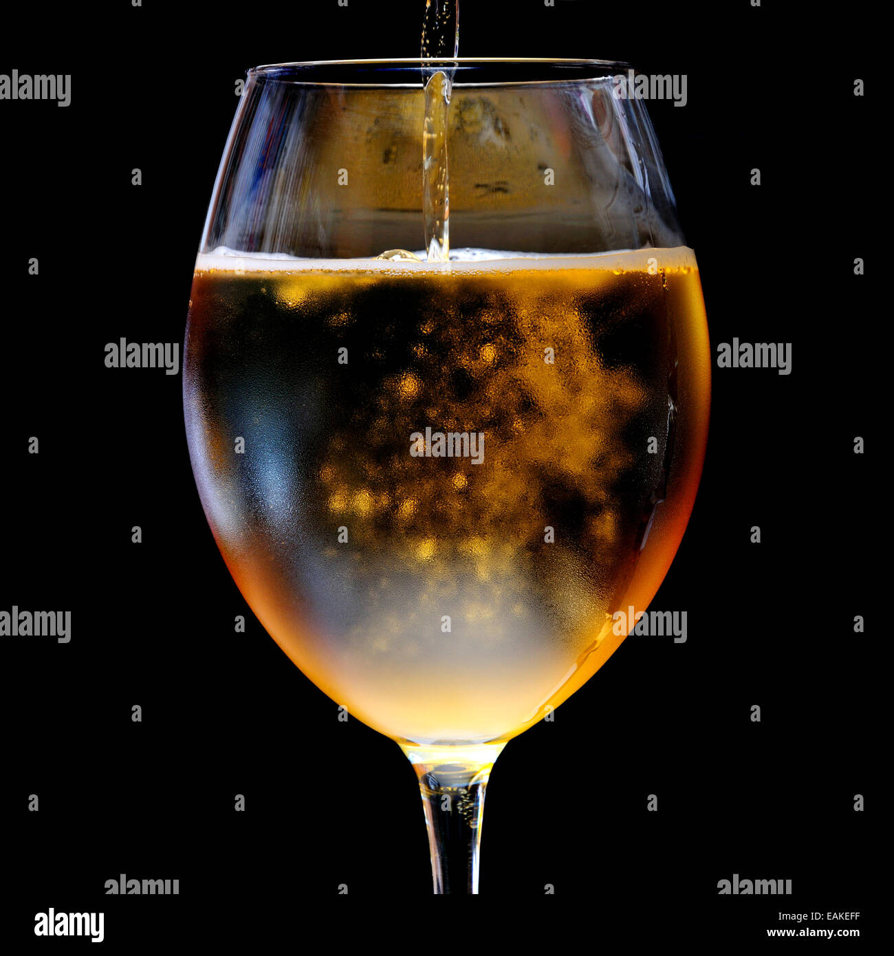 Beer being poured into a large glass Stock Photo