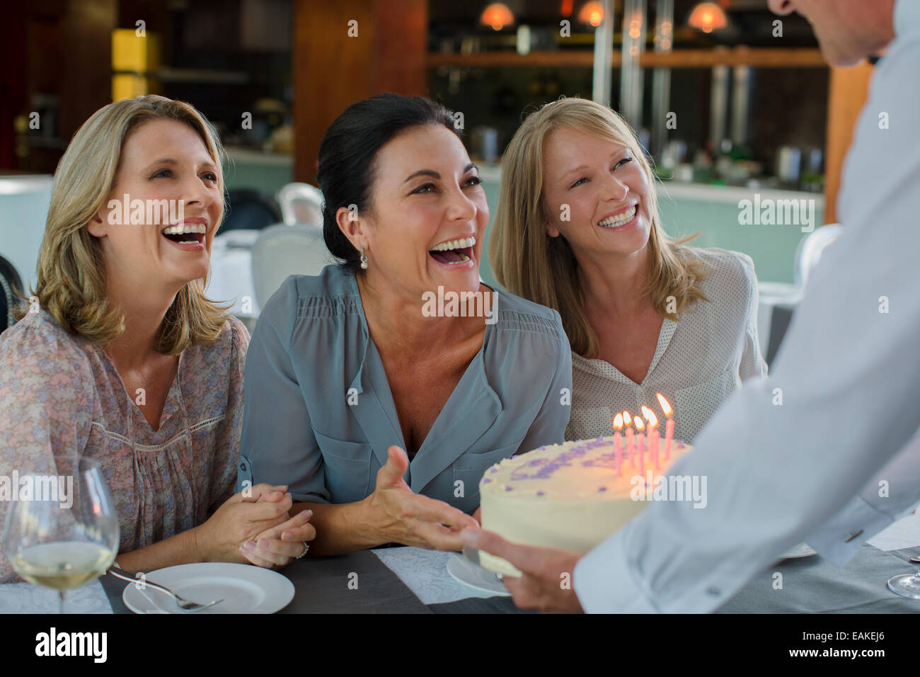 Man handing birthday cake to women Stock Photo