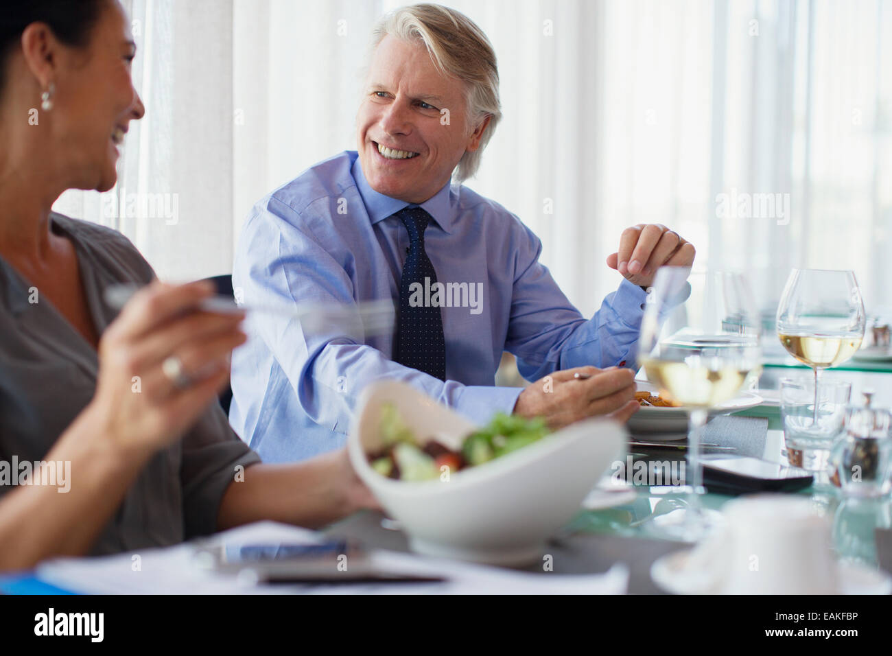 Smiling business people having lunch in restaurant Stock Photo