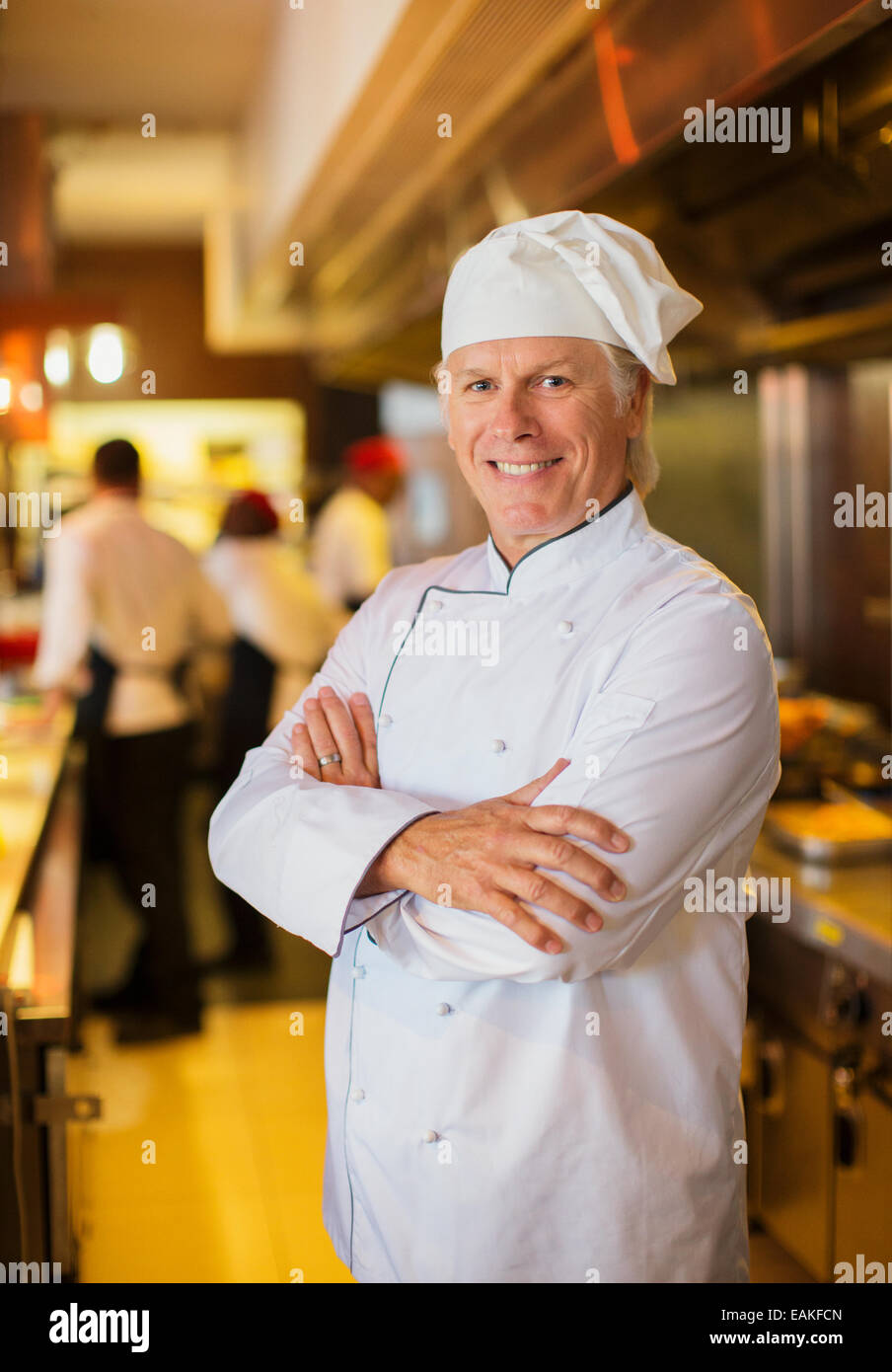 Portrait of smiling chef in restaurant kitchen Stock Photo