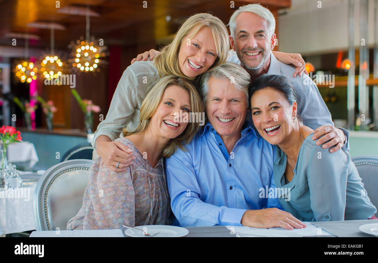 Portrait of smiling mature men and women sitting at restaurant table Stock Photo