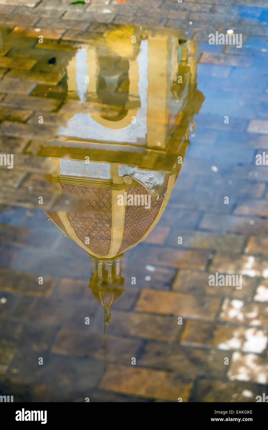 Reflection of Church Tower in Puddle Stock Photo
