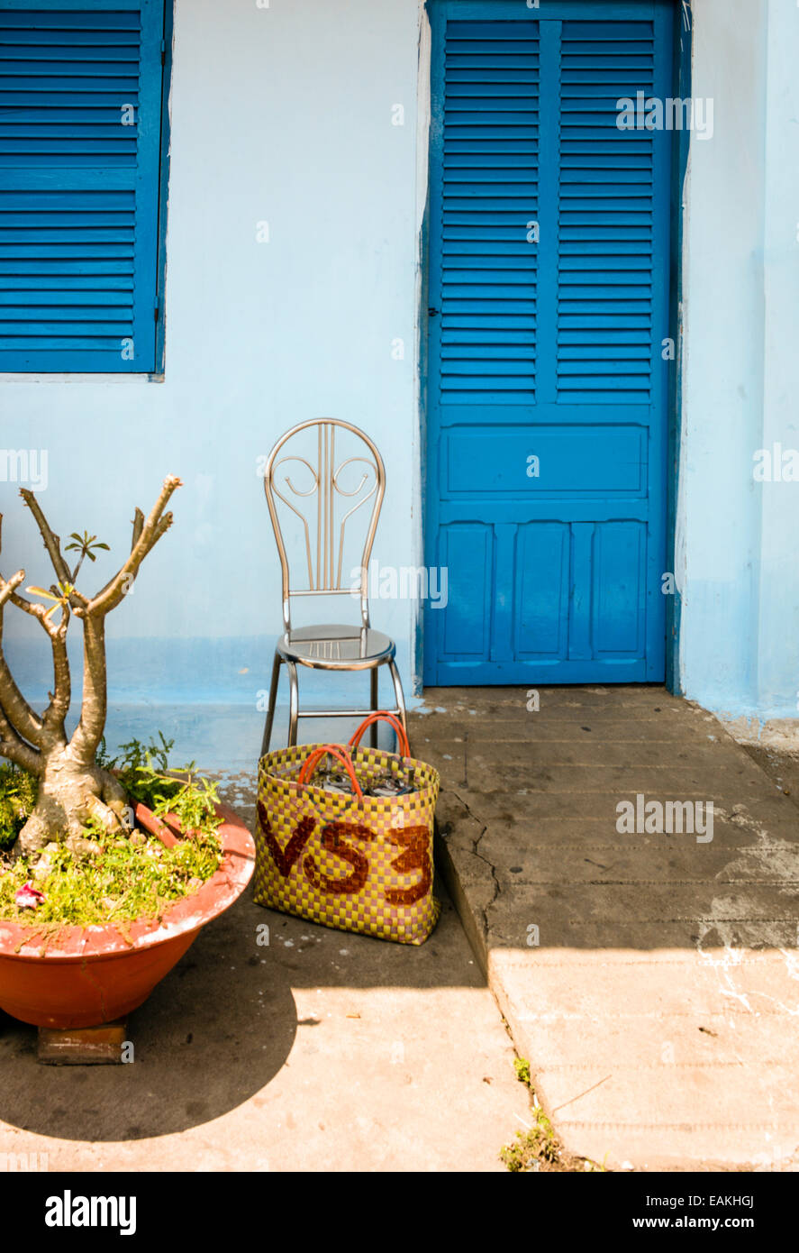 Chair and basket outside the doorway of Vietnam’s Khmer Theravada Buddhist monastery in Tra Vinh. Stock Photo