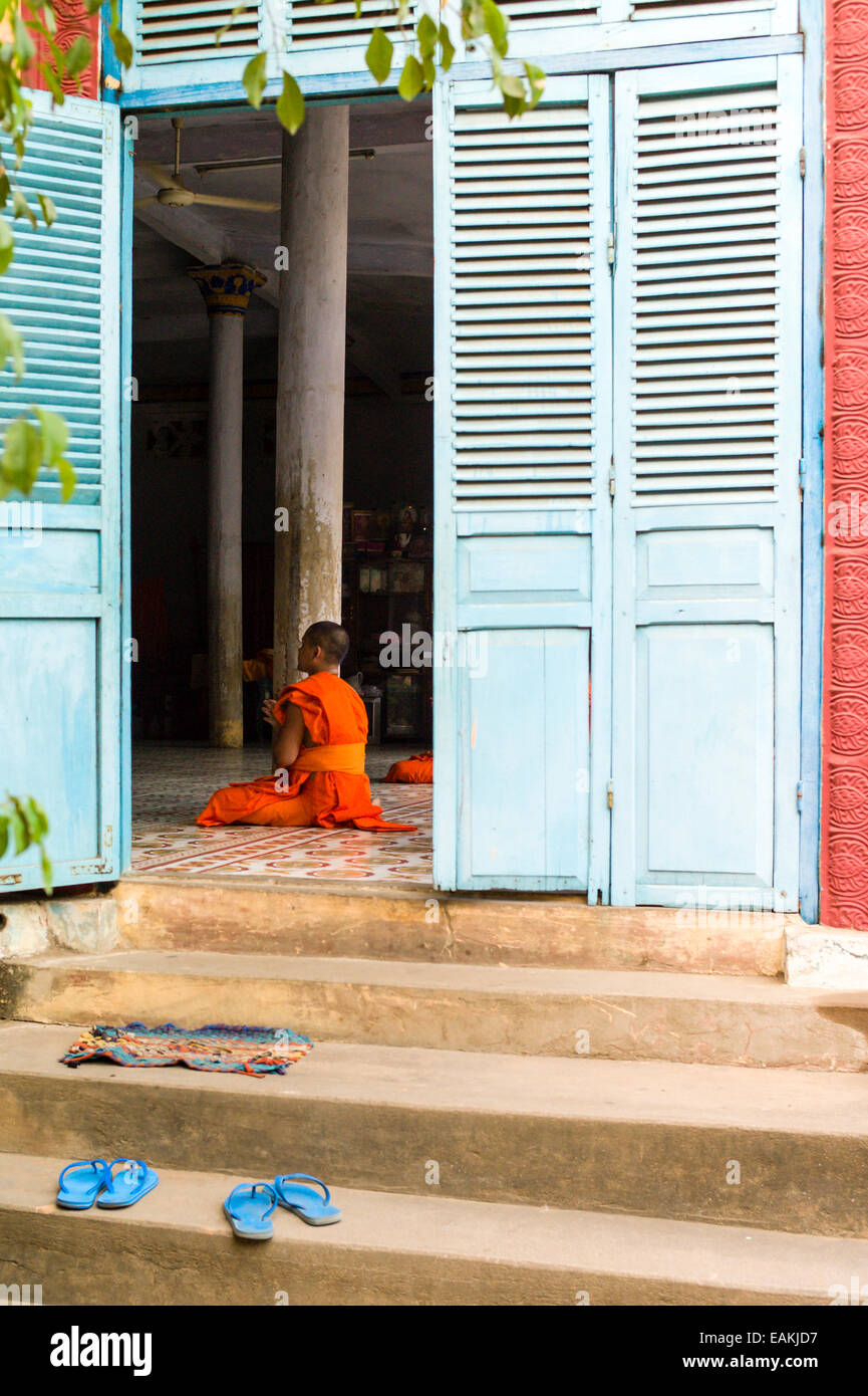 Vietnam’s Khmer Theravada Buddhist monks between the ages of 15 and 20 pray at a monastery in Tra Vinh, Vietnam. Stock Photo