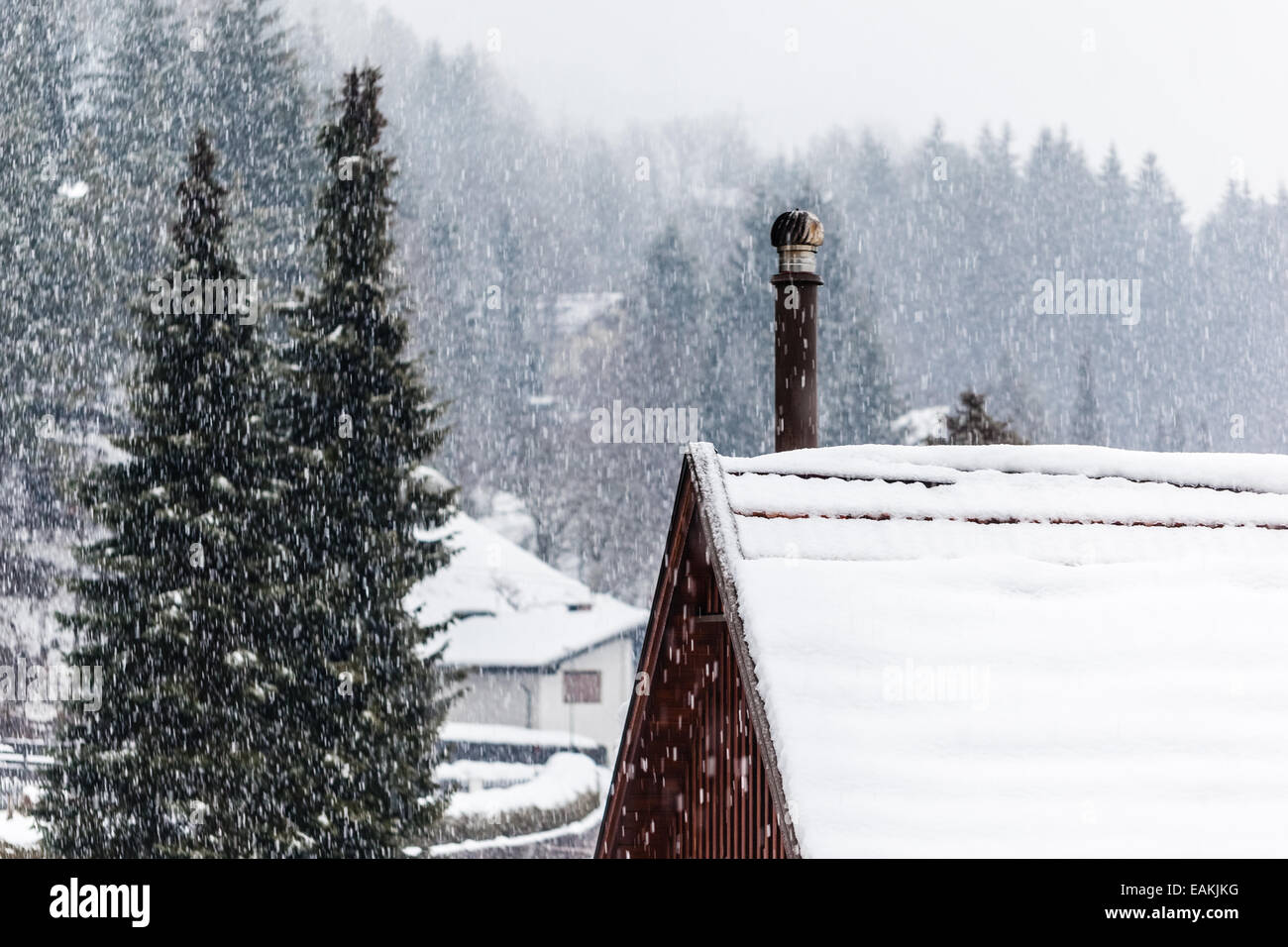 detail of a roof covered with snow with a smoking chimney Stock Photo ...