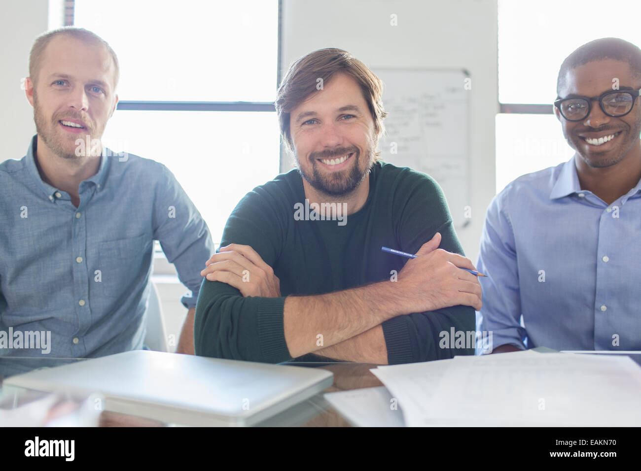 Portrait of three smiling businessmen in office Stock Photo - Alamy