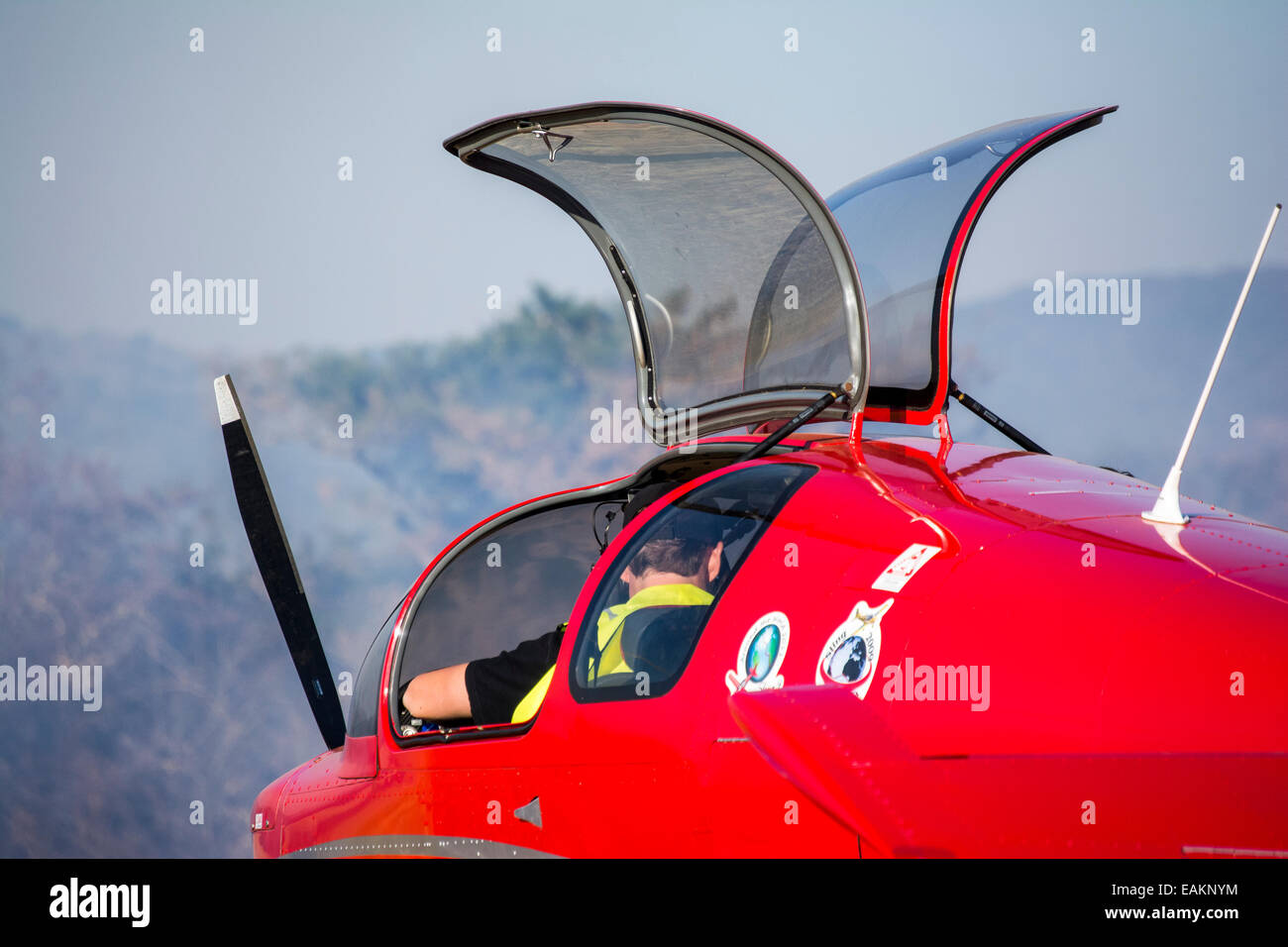 Pilot sitting inside his light aircraft with the doors open Stock Photo