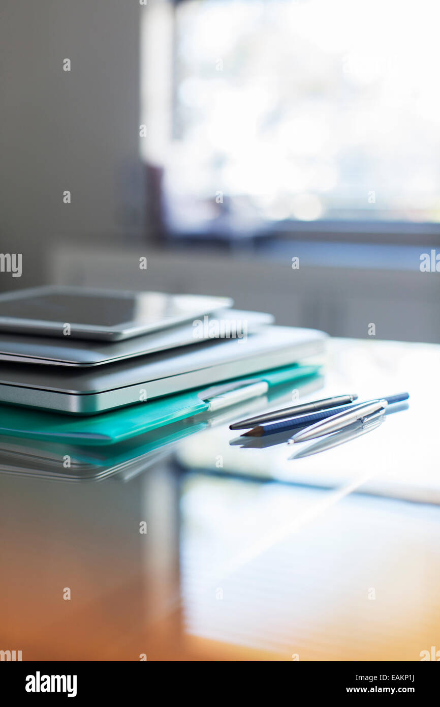 Documents and digital tablet on desk in office Stock Photo