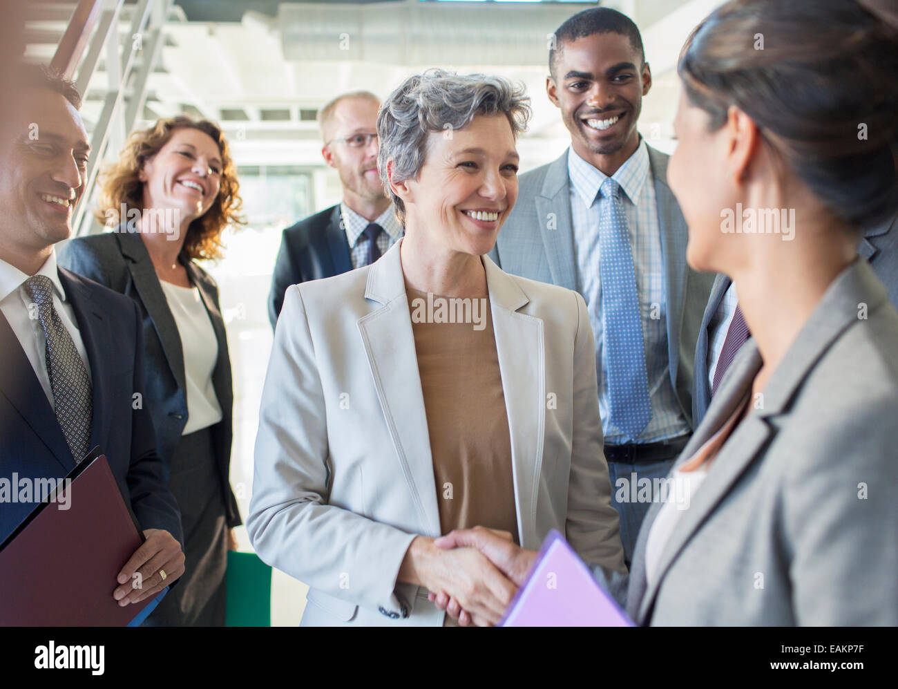 Office team congratulating businesswoman Stock Photo