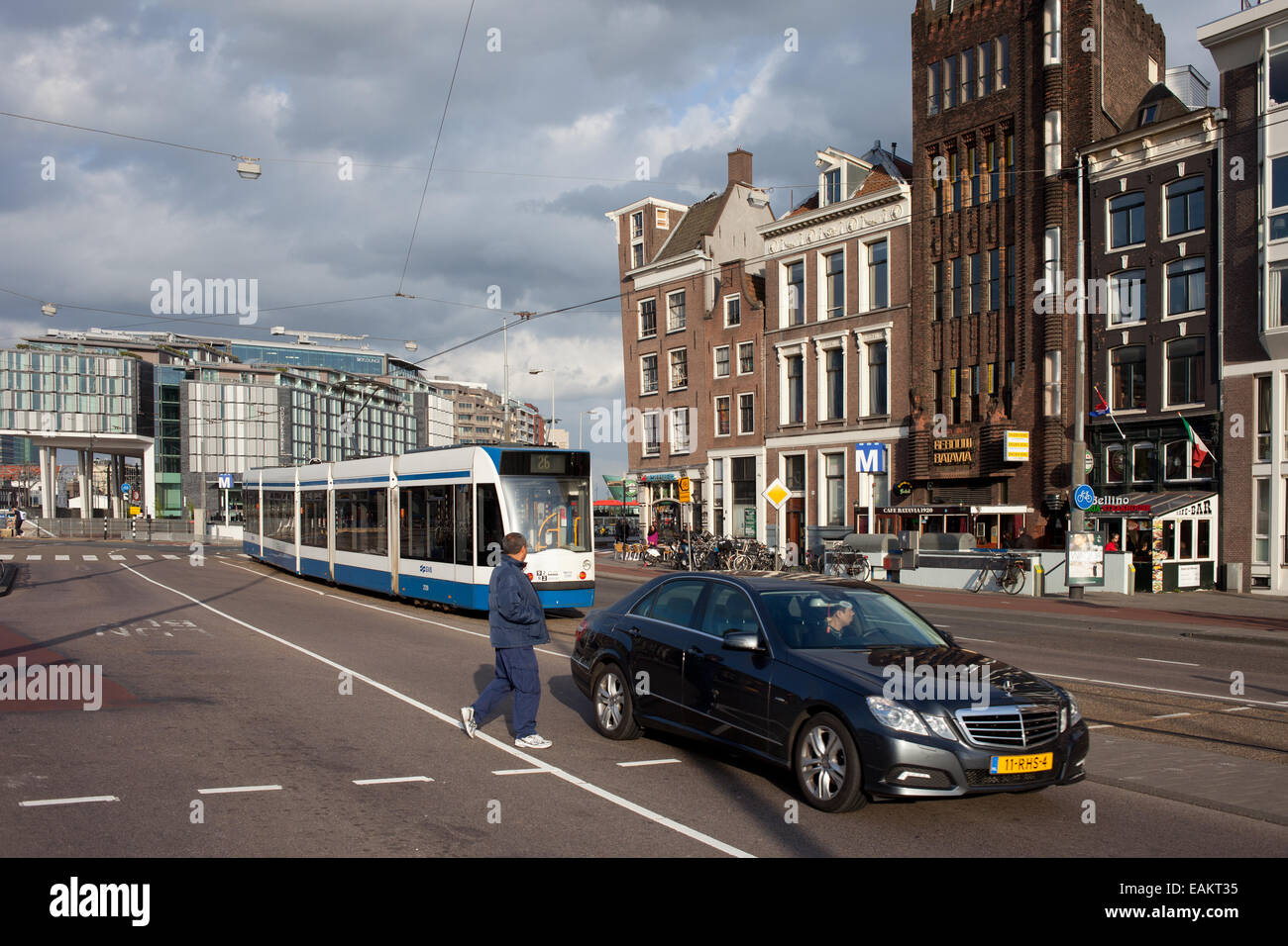 Prins Hendrikkade street in the city centre of Amsterdam in Holland, Netherlands, at the far end DoubleTree Hotel by Hilton. Stock Photo