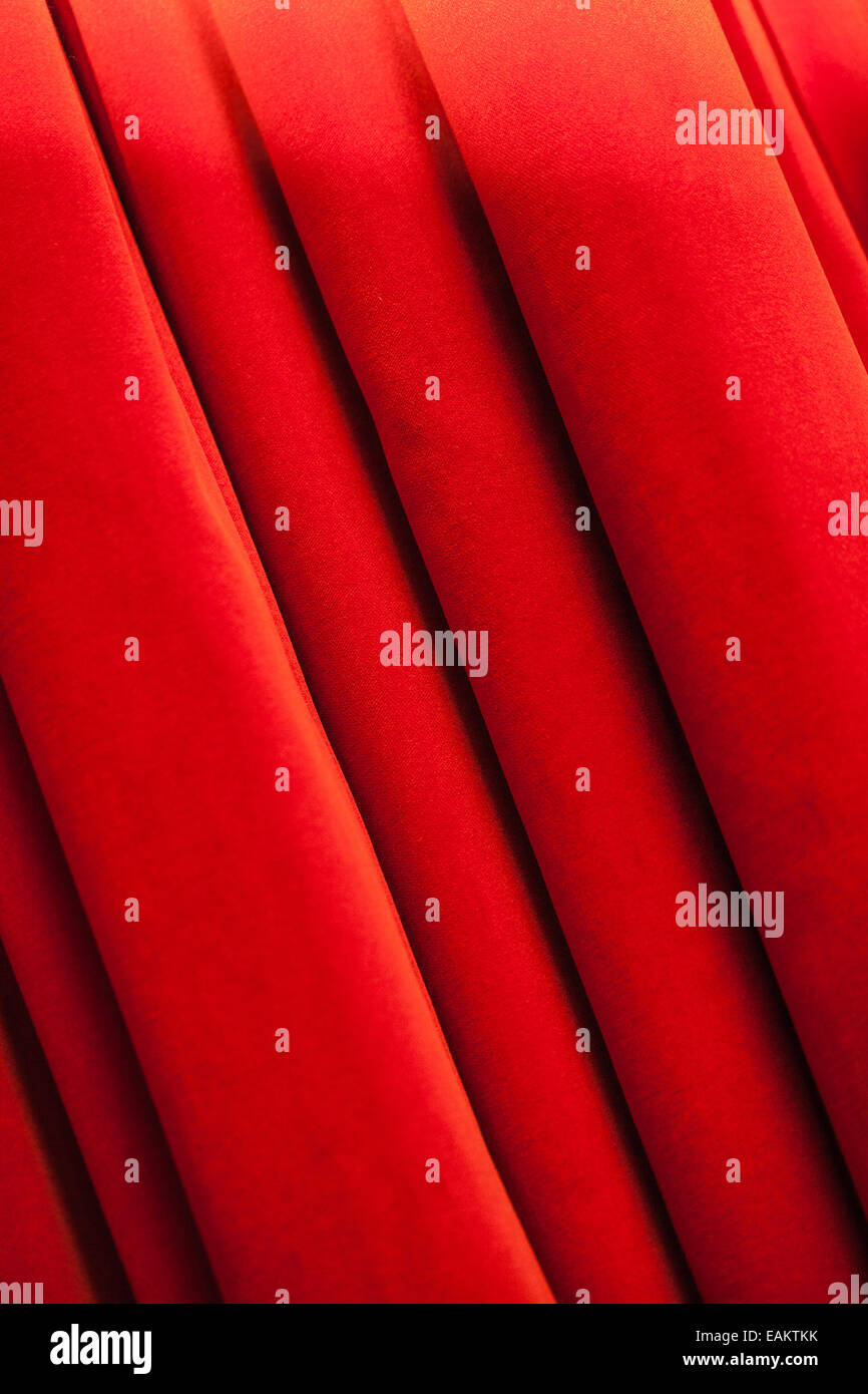 a closed red stage curtain in a small theater Stock Photo