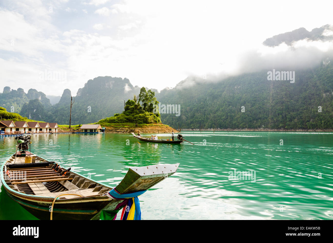 SURAT THANI, THAILAND - APR 27, 2013 : Tourist arrival by long tail boat in the morning at Ratchaprapha Dam at Khao Sok National Stock Photo