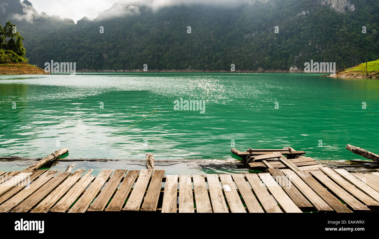 Boardwalk high mountains and green water in morning, Front view of the bungalow at Ratchaprapha Dam, Khao Sok National Park, Sur Stock Photo