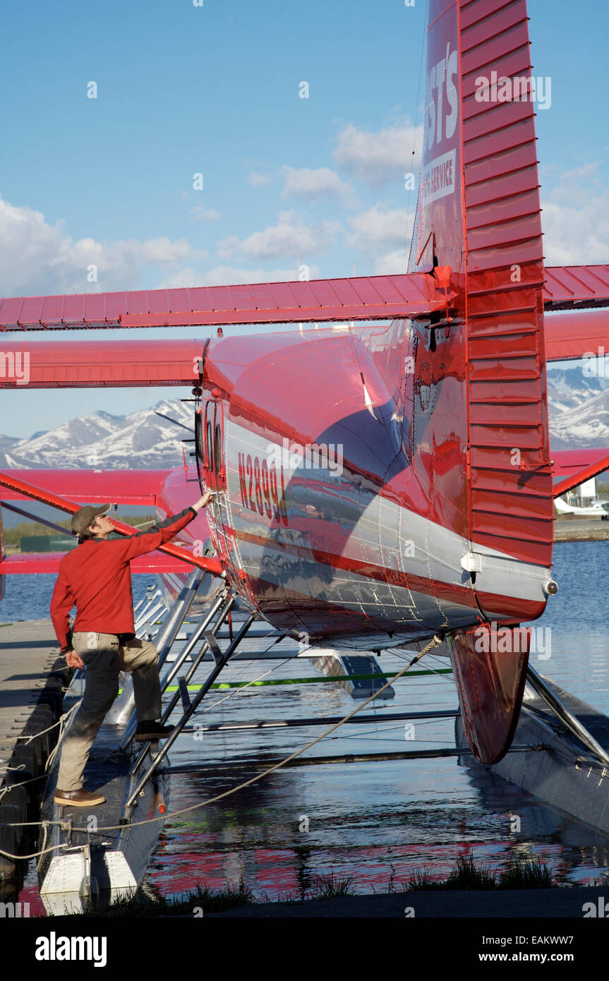 Pilot With Rust's Flying Service Prepares His Plane For Flight At Lake