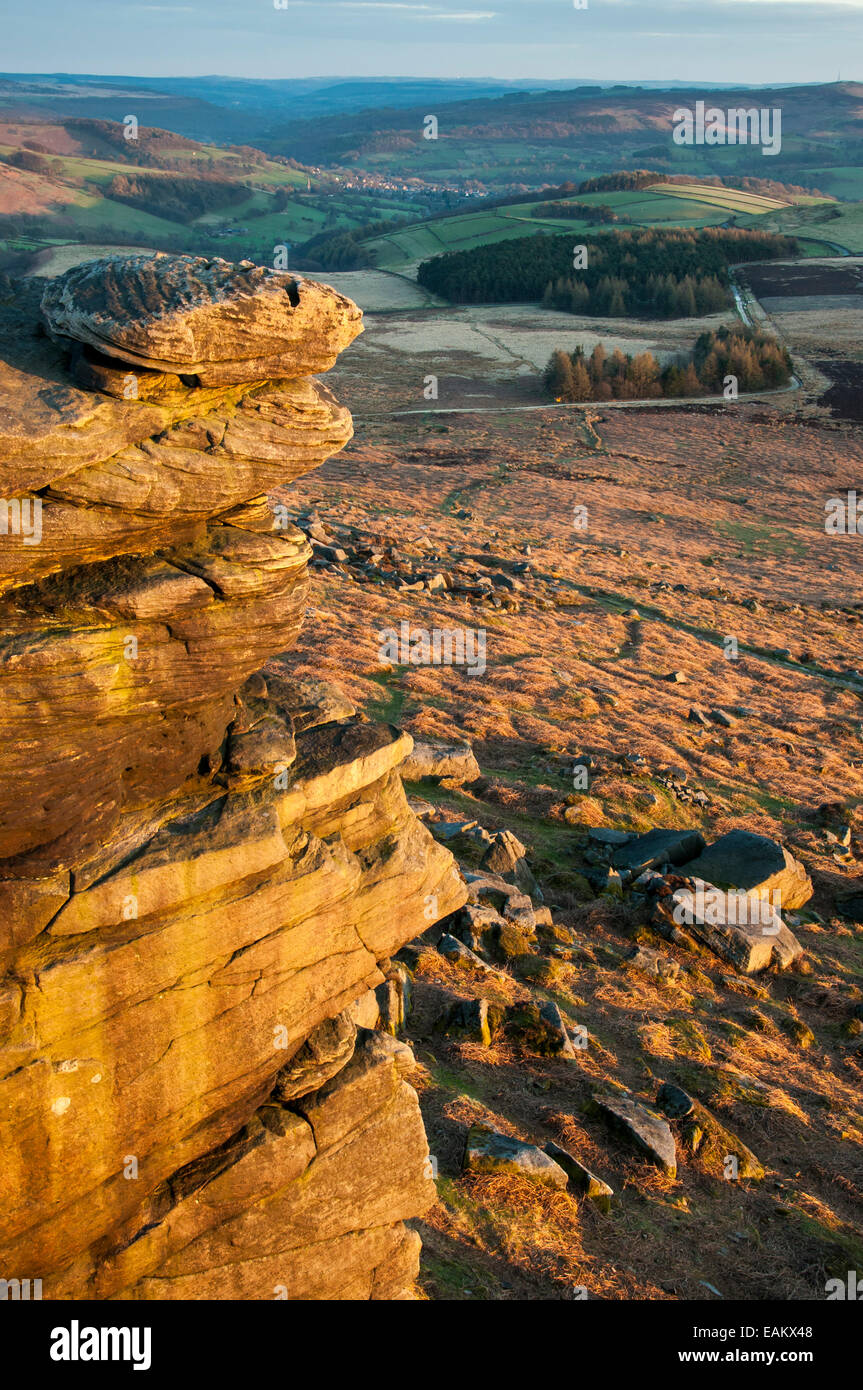 View from Stanage Edge at dusk with golden glow on gritstone rocks. Stock Photo