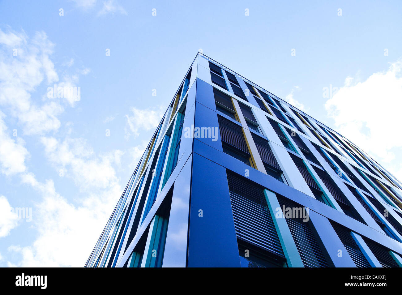 High building with blue sky above Stock Photo - Alamy