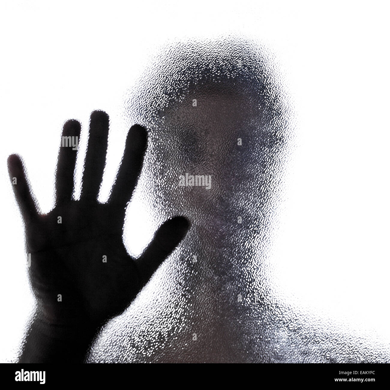 man's hand behind milk glass, touching a glass, on a glass, against a