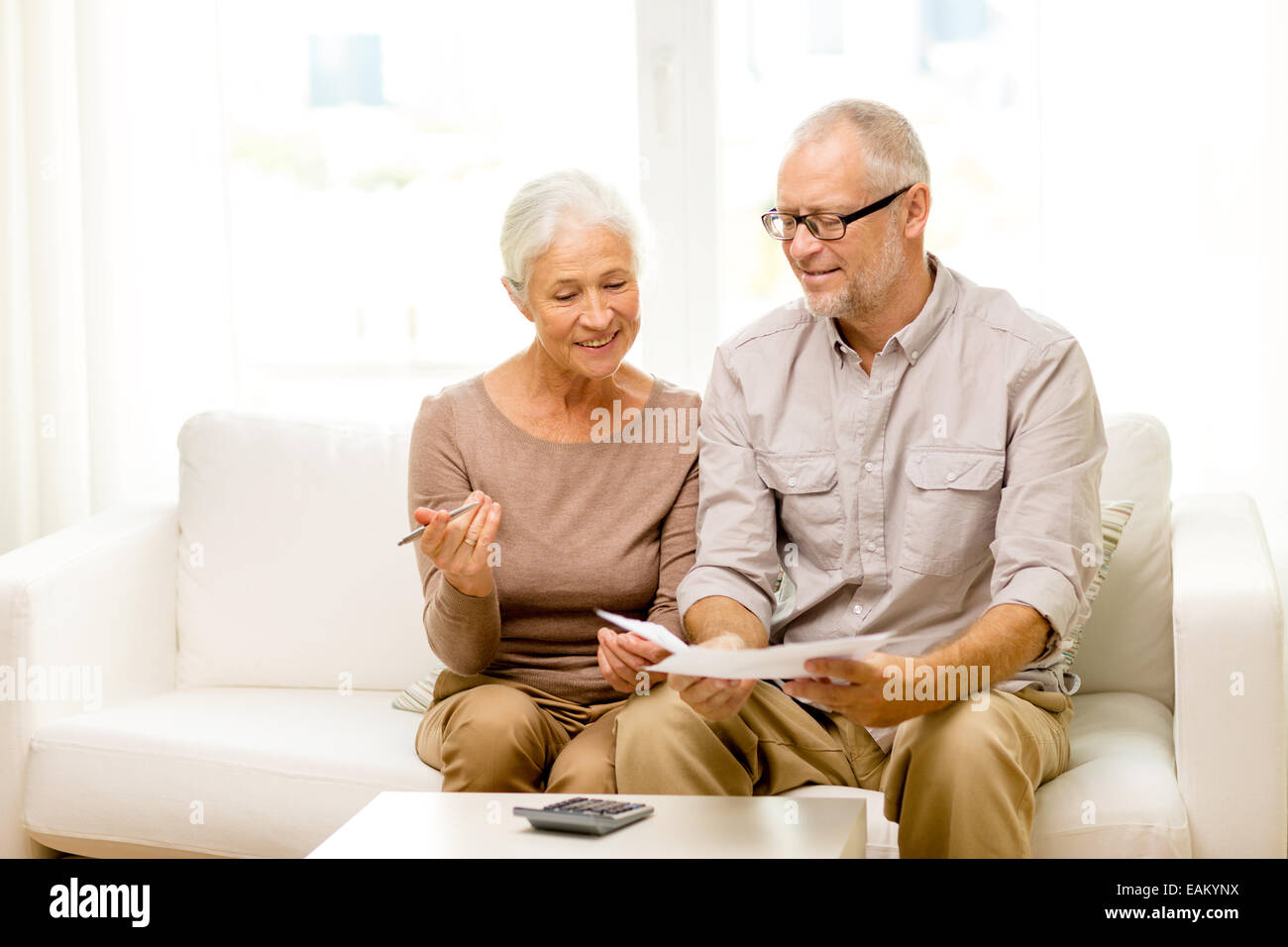 senior couple with papers and calculator at home Stock Photo