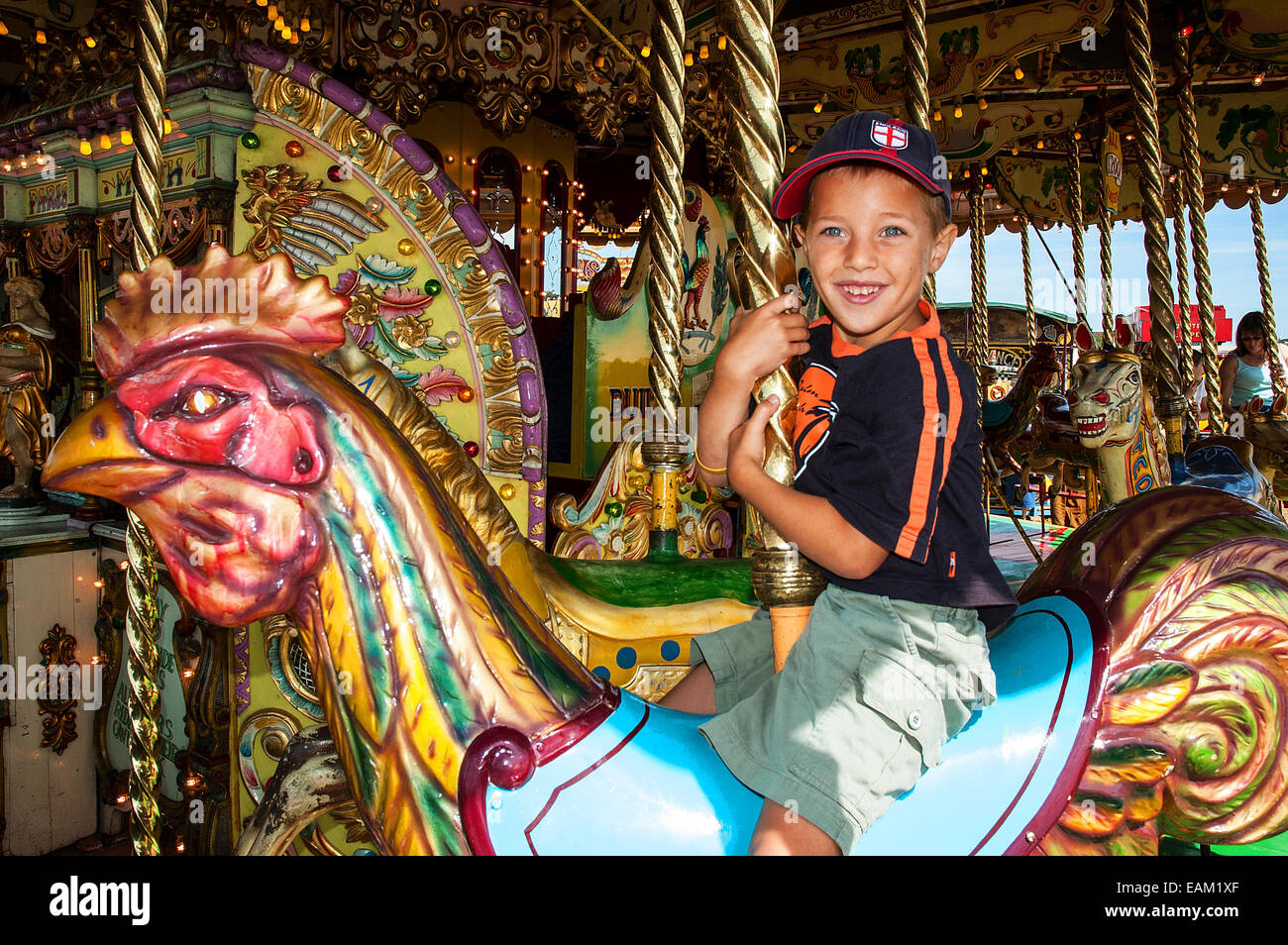 little boy on a merry go round at the fun fair in southport, england, uk Stock Photo